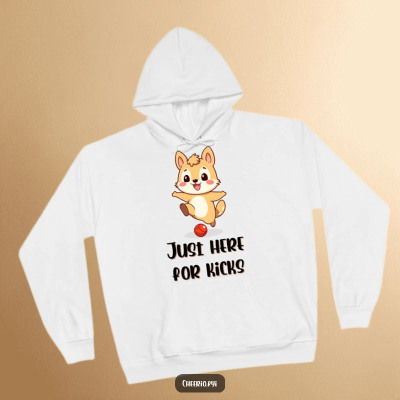 Funny hoodie graphic of a gleeful animal character focused on kicking a small red ball across a field with a wide grin.